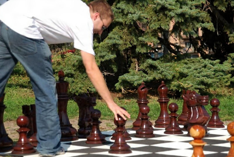 Elegant Outdoor Chess Collection oversized outdoor chess set in luxury tropical resort environment