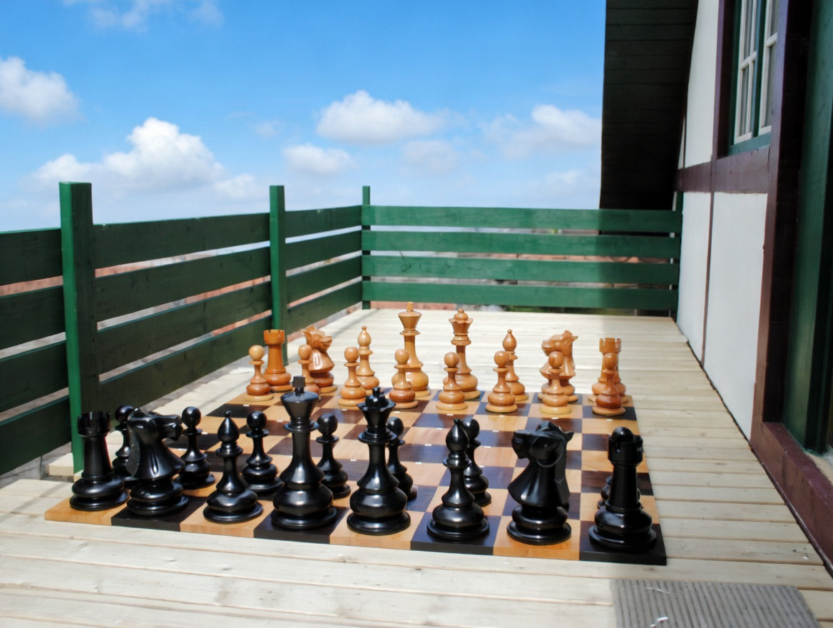 Modern Luxury Chess Lifestyle oversized outdoor chess set in luxury tropical resort environment