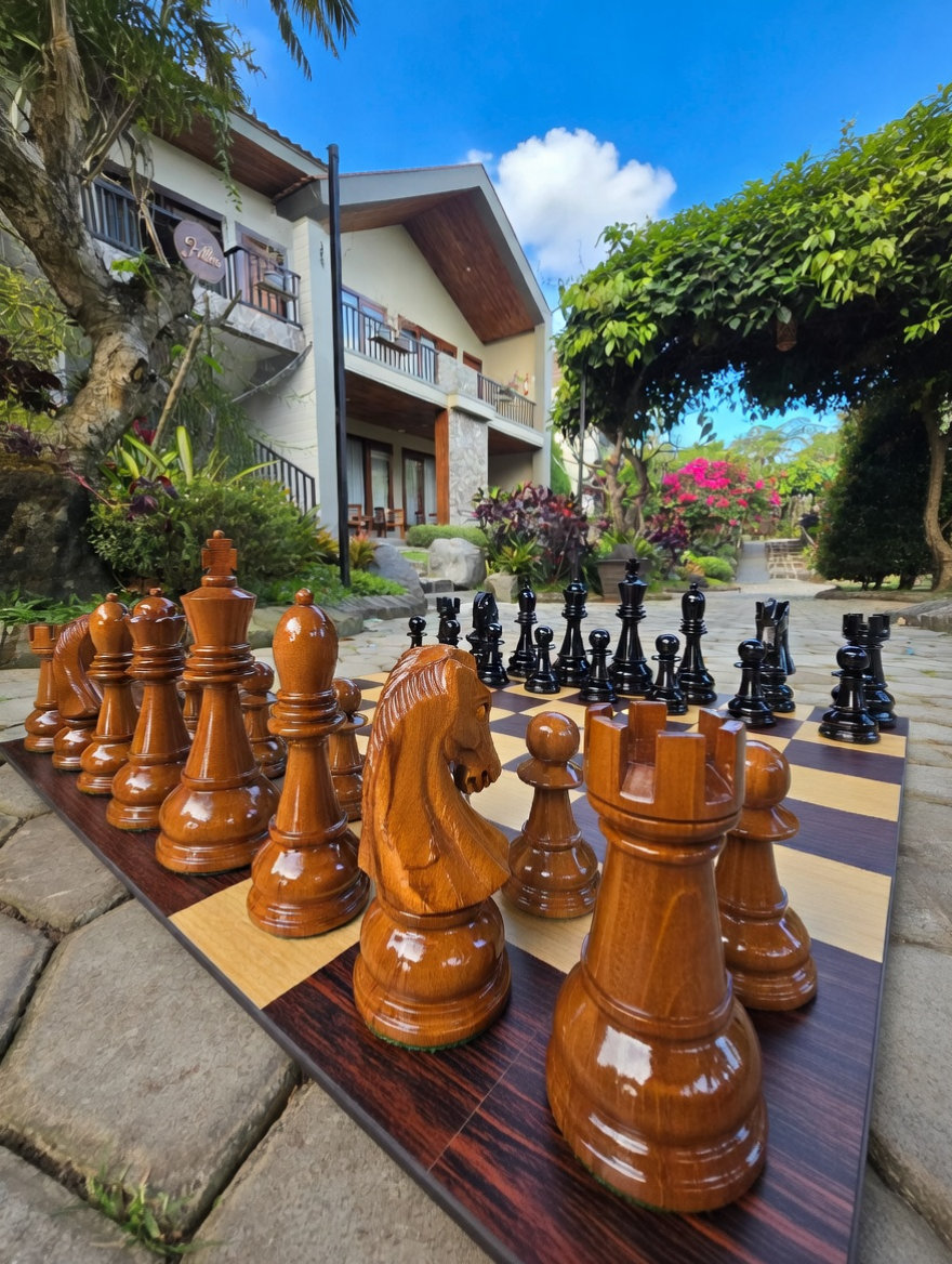 Elegant Outdoor Chess Collection oversized outdoor chess set in luxury tropical resort environment