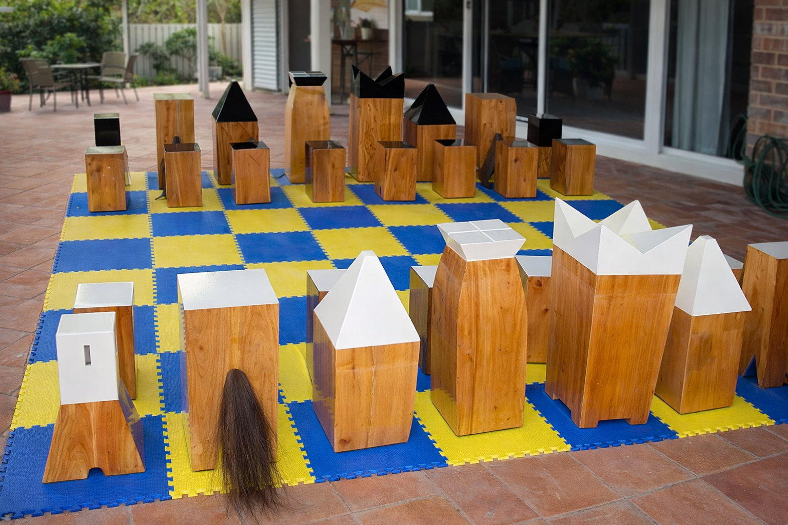 Premium Garden Chess Installation oversized outdoor chess set in luxury tropical resort environment