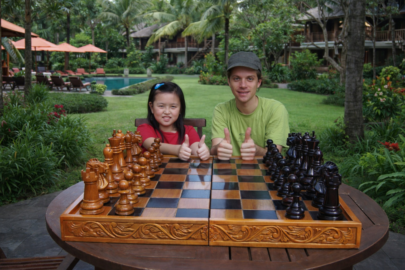 Elegant Outdoor Chess Collection oversized outdoor chess set in luxury tropical resort environment