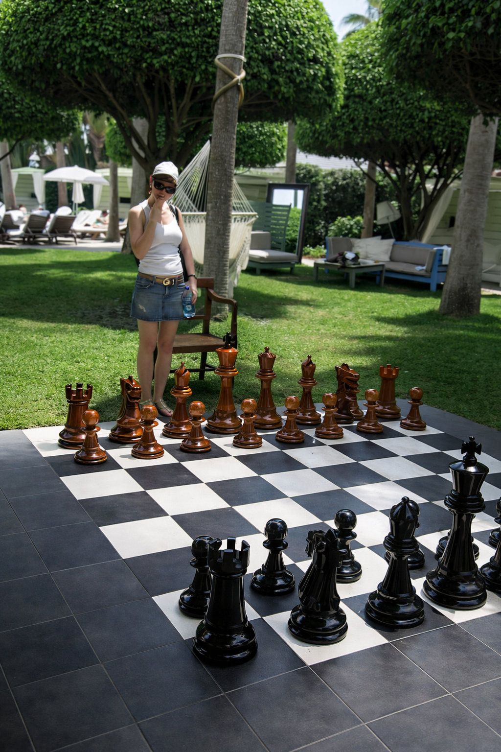 Elegant Outdoor Chess Collection oversized outdoor chess set in luxury tropical resort environment