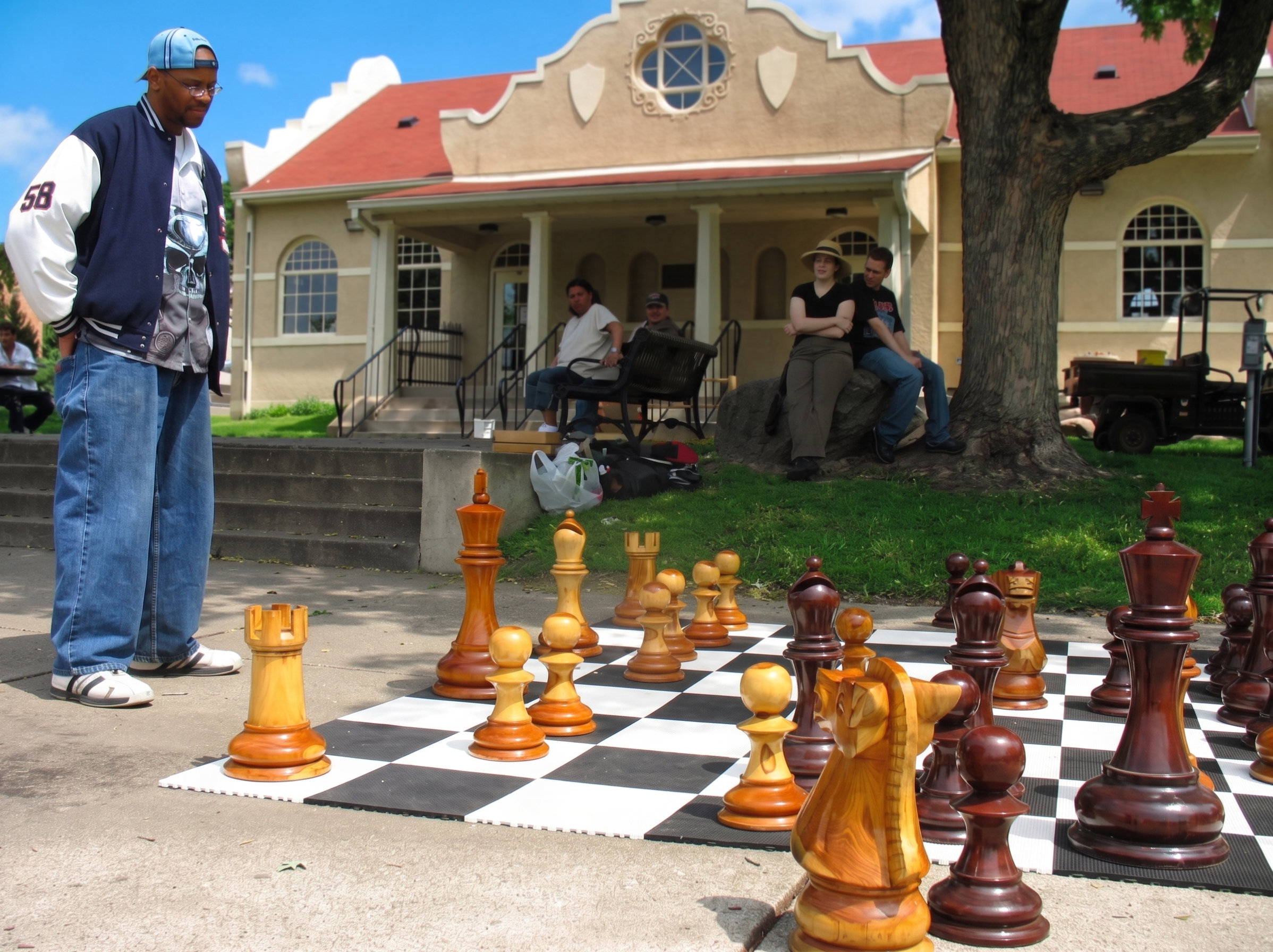 Modern Luxury Chess Lifestyle oversized outdoor chess set in luxury tropical resort environment