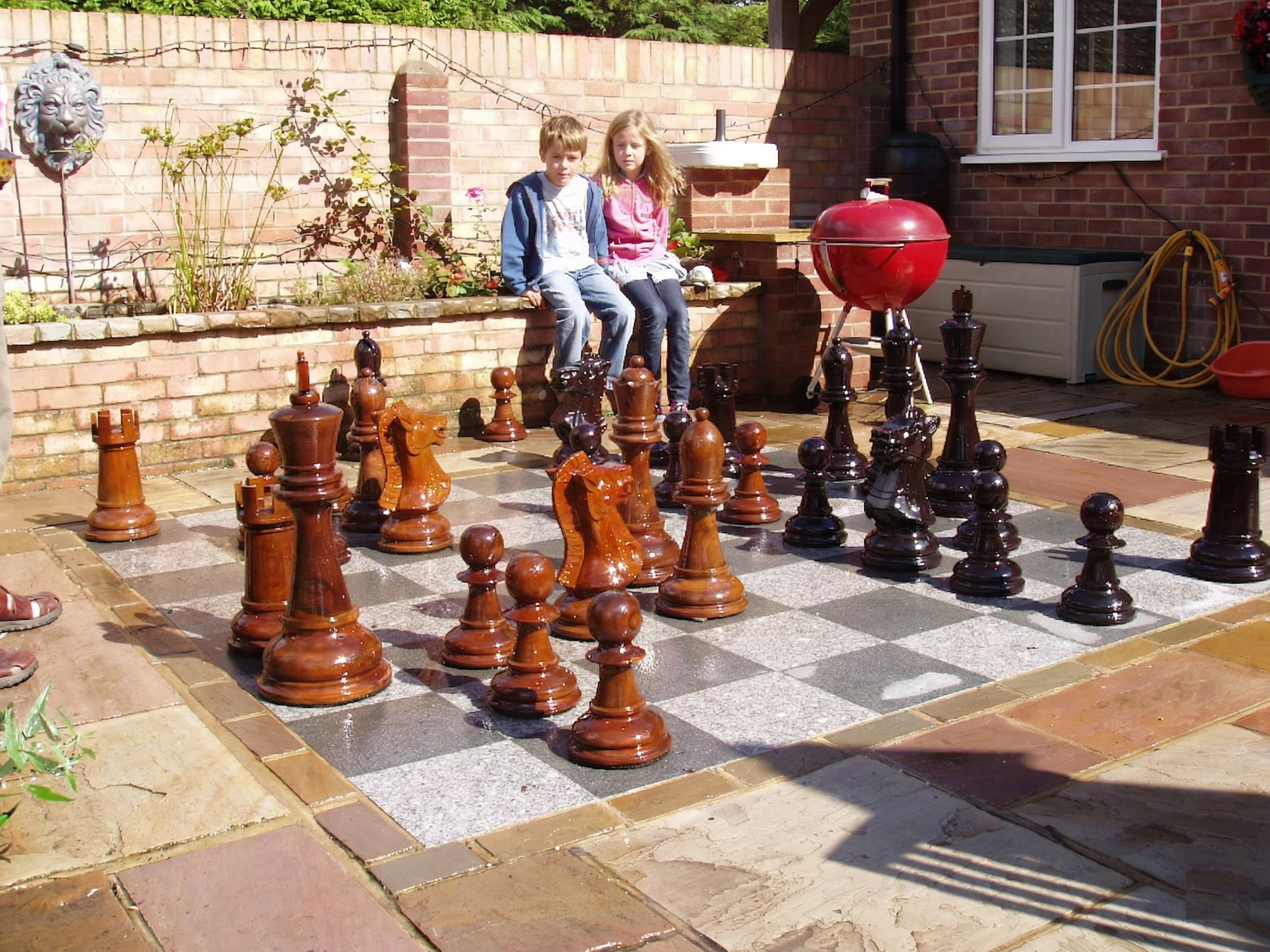 Premium Garden Chess Installation oversized outdoor chess set in luxury tropical resort environment